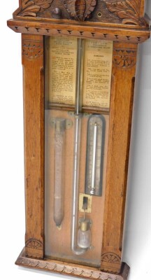 An early 20thC Admiral Fitzroy oak cased improved barometer, with 25cm diameter main dial, mercury column and thermometer, in heavily carved case, with adjusting knop surmounted by acanthus leaf and orb finials, 117cm high. - 3