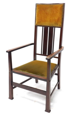 A mahogany high backed Edwardian open armchair, with padded back and seat, on block feet.