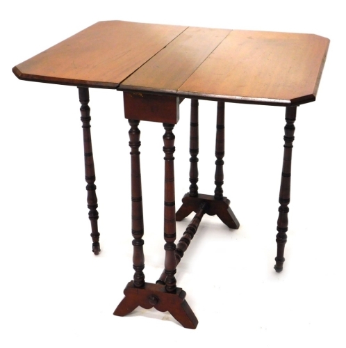 An Edwardian Sutherland table, the canted top on turned legs terminating in scroll feet, when closed 66cm high, 61cm wide, 21cm deep.