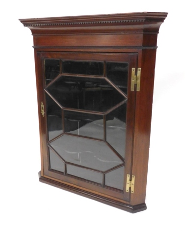 A 19thC mahogany hanging corner cupboard, the moulded dentil cornice raised above an astragal glazed door revealing interior shelves, 107cm high, 80cm wide, 54cm deep.