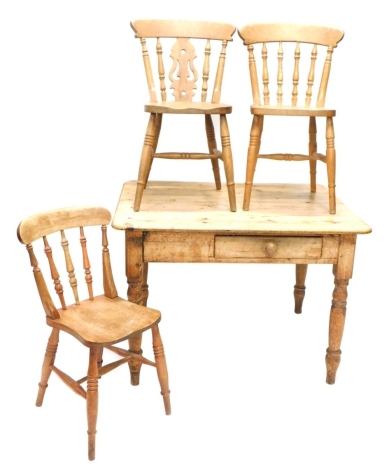 A late 19thC pine kitchen table, with single drawer to the frieze, on turned legs, 76cm high, 117cm wide, 90cm deep, and three various beech dining chairs.