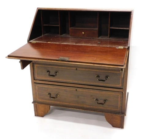 An Edwardian mahogany and satinwood cross banded bureau, the fall enclosing a fitted interior above three graduated drawers on bracket feet, 76cm wide.