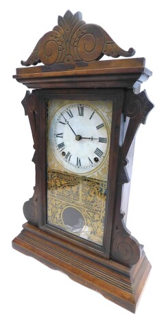 A late 19thC American mantel clock, in a carved and engraved walnut case, with white paper dial, verre eglomise door decorated in gilt, on a plinth, 53cm high.