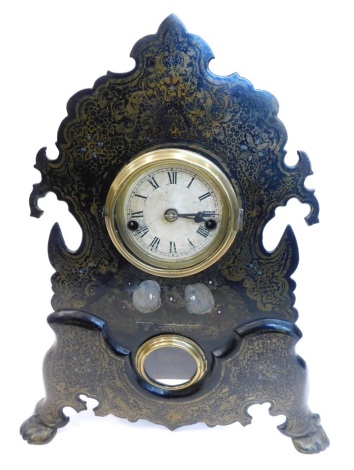 A late 19thC American mantel clock by the Waterbury Clock Company, in a black toleware case, decorated in gilt to simulate papier mache, the paper dial with Roman numerals above a small aperture for pendulum, bell, etc., 42cm high.