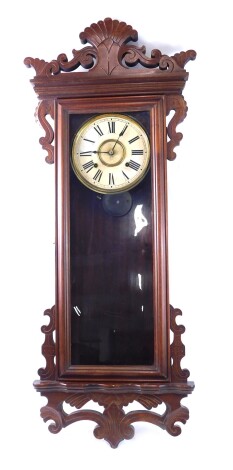 A late 19thC American wall clock, in walnut case, with carved brackets, etc., the paper dial stamped for The Ansonia Clock Company, and with Roman numerals, with a long glazed door, 78cm high.