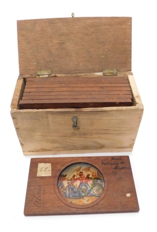 A box of various magic lantern slides, one handwritten Davis, marked Alicia in colours, 8cm wide and various others in a pine box.