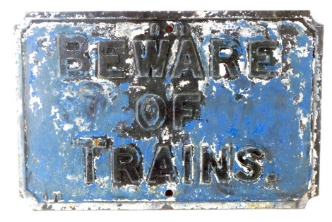 A 20thC cast iron Beware of Trains sign, raised in black lettering on blue ground, 40cm x 52cm.