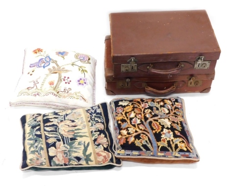 A pressed leather travel trunk, another and two petit point cushions, 43cm wide. (a quantity)