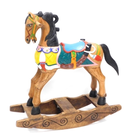 A modern wooden rocking horse, painted in colours on a rocker base (AF), 94cm high.