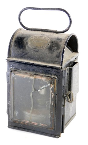 A 20thC LMSR Wolverton iron railway lantern, with fixed handle, domed body and front glass, 27cm high. (AF)