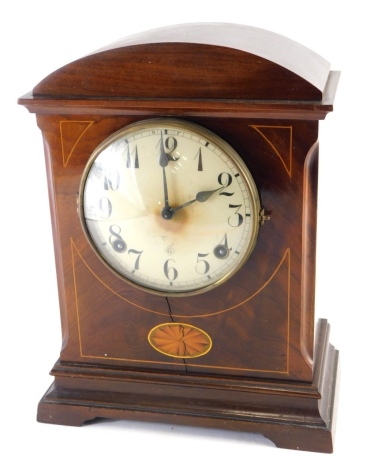 An Edwardian mahogany and boxwood strung mantel clock, in domed case, with 13cm Arabic dial, chiming on the hour, with pendulum, 32cm high. (lacking back)