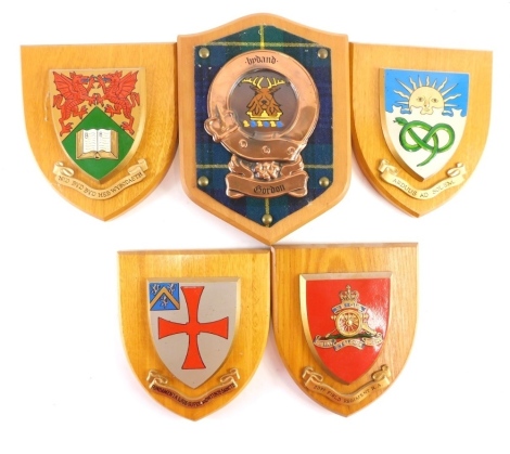 Five various oak shield plaques, William Clancy Heraldic Art and others, to include Gordon Family, 23cm high, various other shield shaped plaques. (5)