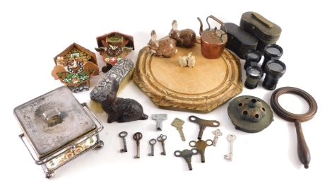 An early 20thC treen chopping board, a silver plated sardine dish with pottery centre, cuckoo clock, opera glasses, miniature copper kettle, silver topped clothes brush, rabbit ornaments, etc. (a quantity)