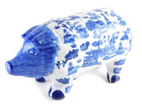 A 20thC UK Sculptures pig money box, blue transfer printed, 26cm high.