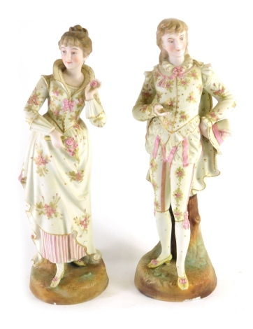 A pair of Continental bisque porcelain figures of a lady and gentleman, each dressed in finery, on tree work bases, 35cm high, unsigned. (2)