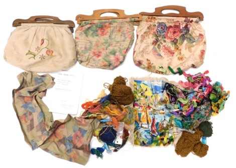 Various early 20thC embroidered linen bags, with wooden handles, a quantity of wool, etc., each bag approx 33cm wide.