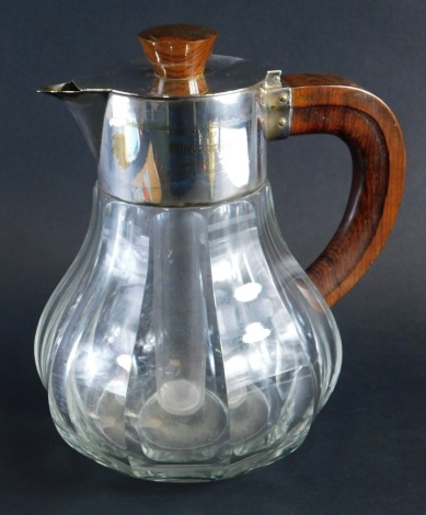 A 20thC serving jug, with silver plated mounts wooden handle and knop, articulated lid and stopper, 33cm high.