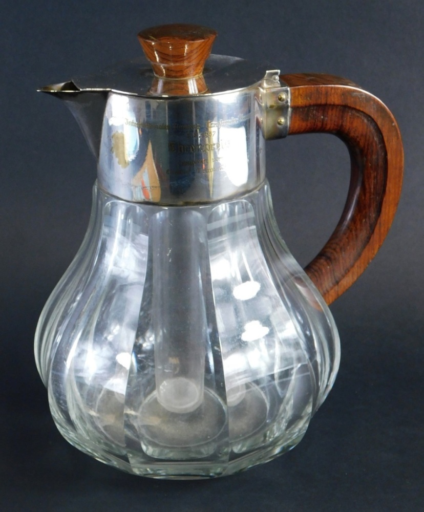 A 20thC serving jug, with silver plated mounts wooden handle and knop