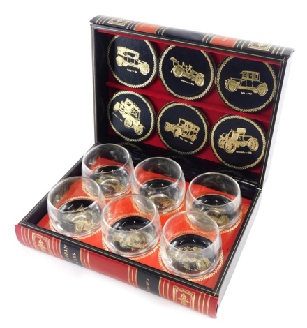 A modern Veteran car decanter set formed as books, hinging to reveal six glasses with coasters, 8cm high, 26cm wide, 19cm deep.