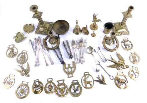 Various brassware, a pair of early 20thC candlesticks with cylindrical dish holders, 23cm high, various horse brasses, bowl, squat candlesticks, various other metalware, nut crackers, etc. (a quantity)