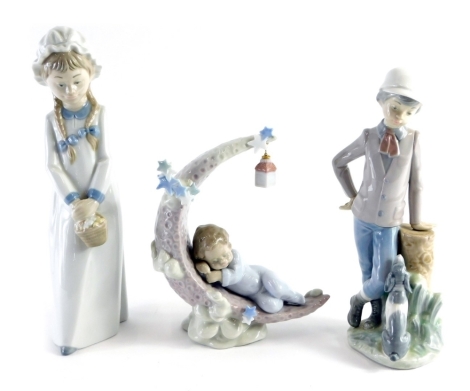 A Lladro figure group of a sleeping child, on crescent moon with hanging lantern, number 6479, printed and impressed marks beneath, 19cm high, a Nao figure of a girl and a further figure of child aside puppy. (3)