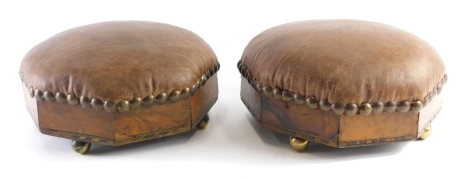 A pair of early 20thC walnut stools, with leather studded tops on orb feet, 27cm wide.