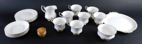 A Royal Albert Val D'Or pattern part tea service, to include serving plate, milk jug, sugar bowl, cups, saucers, etc., printed marks beneath, part settings for six, and a black poplar carved bowl, signed beneath. (a quantity)