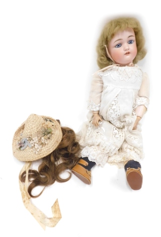 A late 19thC Schoenau Hoffmeister SPBH bisque headed doll, with blonde hair, fixed blue eyes, open mouth showing teeth, with articulated limbs, in linen dress with later straw finish hat, the head, 10cm high, 53cm high overall.