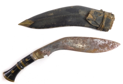 A 20thC kukri, with shaped blade, turned handle and leather scabbard, 41cm long.