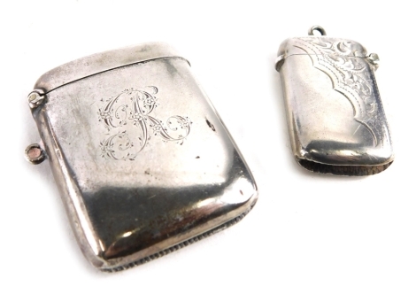 An Edward VII silver Vesta case, Birmingham 1905, bright cut with flowers with ring top, 4cm high, and another Vesta case, 1.5oz. (2)