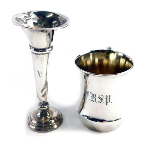 A George V silver cup, by Henry Williamson Limited, with plain handle, initialled, Birmingham 1924, 9cm high, and a single stem vase, 2.76oz all in. (AF, weighted)