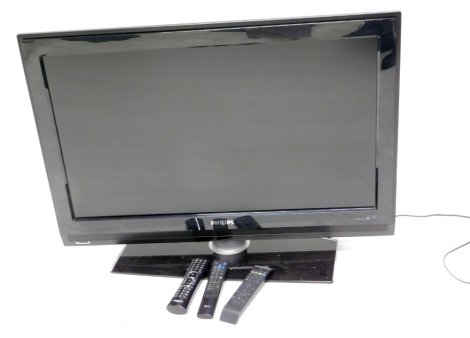 A Philips 36" flat screen TV HD Ready, in black trim, with remote control and wires.