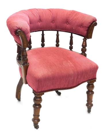 A 19thC tub chair, with C scroll back, serpentine seat on turned front legs, terminating in castors, 86cm high.