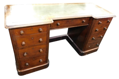 A Victorian mahogany break front twin pedestal desk, with tooled green leather top, raised above three frieze and six pedestal drawers, 75cm high, 140cm wide, 54cm deep.