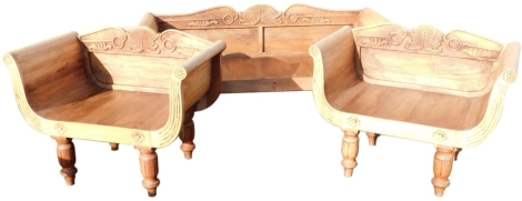 An Eastern colonial style hardwood suite of seating furniture, comprising a sofa with a leaf carved shaped back, solid seat and reeded arm supports, on turned legs and two matching chairs, the sofa 56cm wide, the chairs 104cm wide.