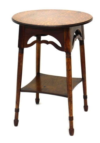 An Early 20thC oak occasional table, with circular top on turned legs joined by an under tier, 70cm high, 51cm diameter.