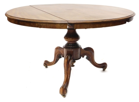 A Victorian mahogany drop leaf table, the circular top with a moulded edge, on a turned column and moulded tripod base.