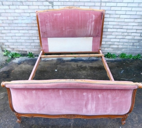 A French style carved beech sleigh bed, with padded back and foot, 150cm wide. The upholstery in this lot does not comply with the 1988 (Fire & Fire Furnishing) Regulations, unless sold to a known exporter or upholsterer it will be cut from the frame befo