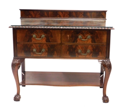 An early 20thC walnut dressing table, of two short and two long drawers, with heavily carved cabriole legs joined by an under tier, with matching chair, the chair 91cm high. (2)