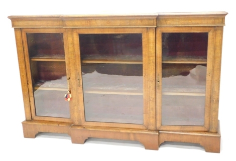 A Victorian walnut breakfront credenza, with giltwood rope twist moulding, above a central door, flanked by two further doors revealing shelves, on bracket feet, 106cm high, 163cm wide, 38cm deep.