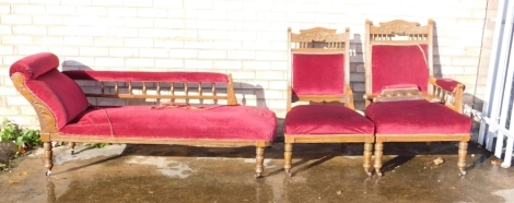 A suite of Edwardian walnut furniture, comprising a chaise longue, gentleman's chair, nursing chair and six side chairs, each in red dralon on turned legs.