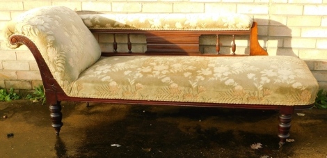 A Victorian walnut framed chaise longue, upholstered to the back and seat in floral material, on turned legs terminating in castors, 75cm high, 77cm wide, 66cm deep.