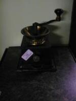 A cast metal and brass Coffee Grinder