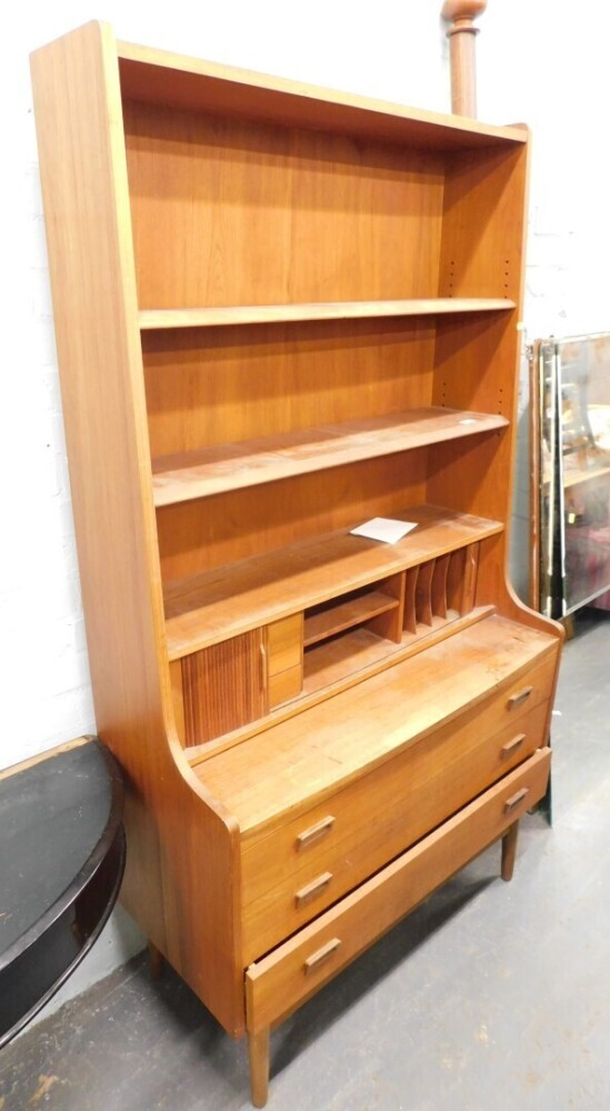 A 1970s teak open cabinet, with pigeon holes and drawers beneath.