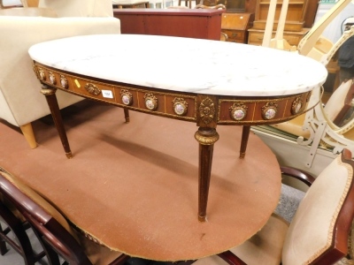 A Continental coffee table, with oval marble finish top, the frieze set with porcelain style plaques, on turned legs.