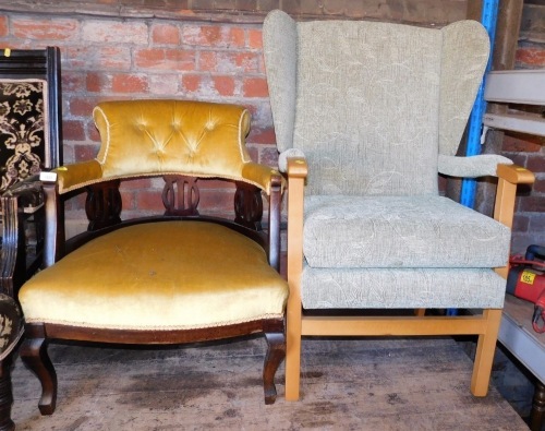 An Edwardian armchair, with a pierced back rail, overstuffed seat, on cabriole legs, together with a 20thC armchair. The upholstery in this lot does not comply with the 1988 (Fire & Fire Furnishing) Regulations, unless sold to a known exporter or upholst