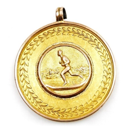 An Edward VII 9ct gold sporting medallion, engraved '120 and 440 Foot Handicap First Prize, Won by AE Holdich at Heckington, 1902.3.4' 13.8g.