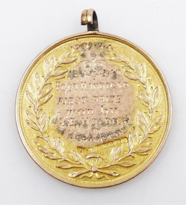 An Edward VII 9ct gold sporting medallion, engraved '120 and 440 Foot Handicap First Prize, Won by AE Holdich at Heckington, 1902.3.4' 13.8g. - 2