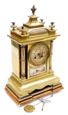 A late 19thC Continental brass mantel clock, circular silvered dial, painted with Roman ruins in the Forum, chapter ring bearing Roman numerals, eight day movement with bell strike, the case of architectural form, the top surmounted by flaming oil lamps a