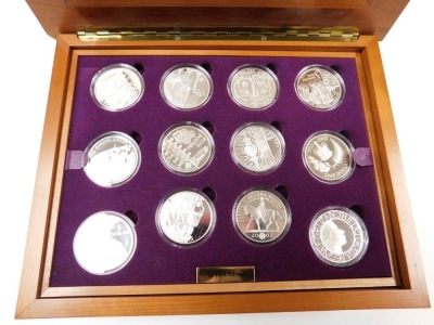 A Royal Mint Golden Jubilee collection, comprising of twenty four silver coins from the twelve Commonwealth countries, in a fitted wooden box with two trays, and explanatory booklet. - 2